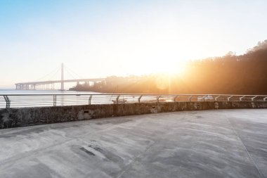 boş beton yol ve altın kapı köprü mavi gökyüzünde güneş ile