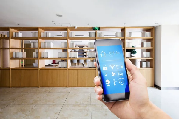 Smart phone in empty room with bookshelf — Stock Photo, Image
