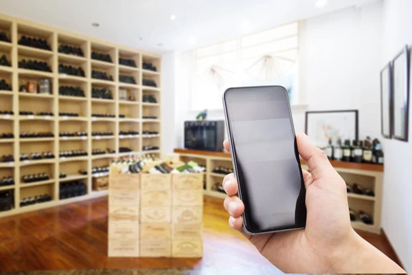 Mobile phone in modern wine cellar — Stock Photo, Image