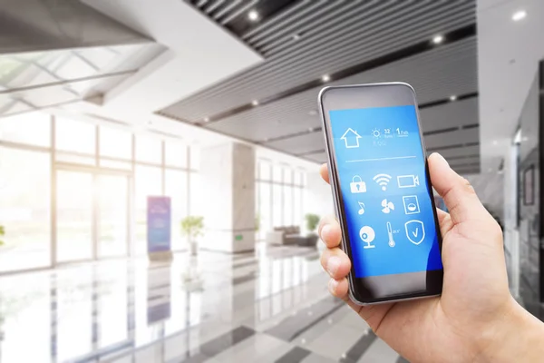 Smart phone in modern spacious hall — Stock Photo, Image