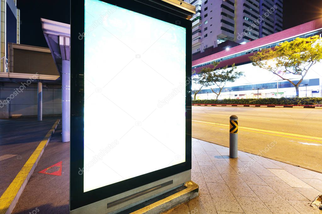blank billboard on street in midtown of Singapore at night