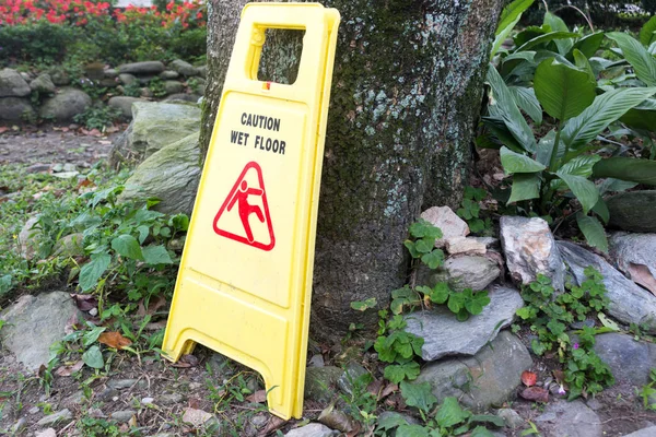 yellow plastic wet floor sign on ground