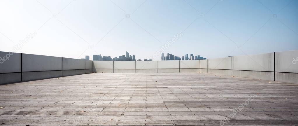 empty brick floor and cityscape of Hangzhou in blue cloud sky