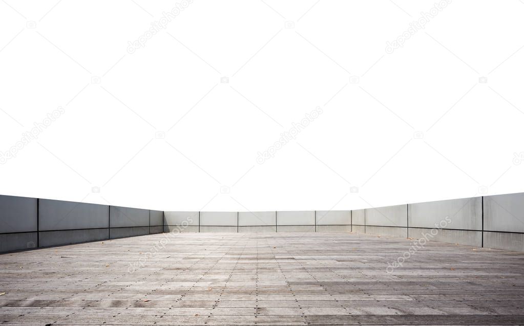 empty brick floor surrounded by concrete wall in blue sky