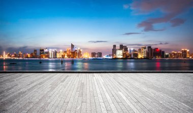 empty brick floor and cityscape of Hangzhou in blue cloud sky clipart