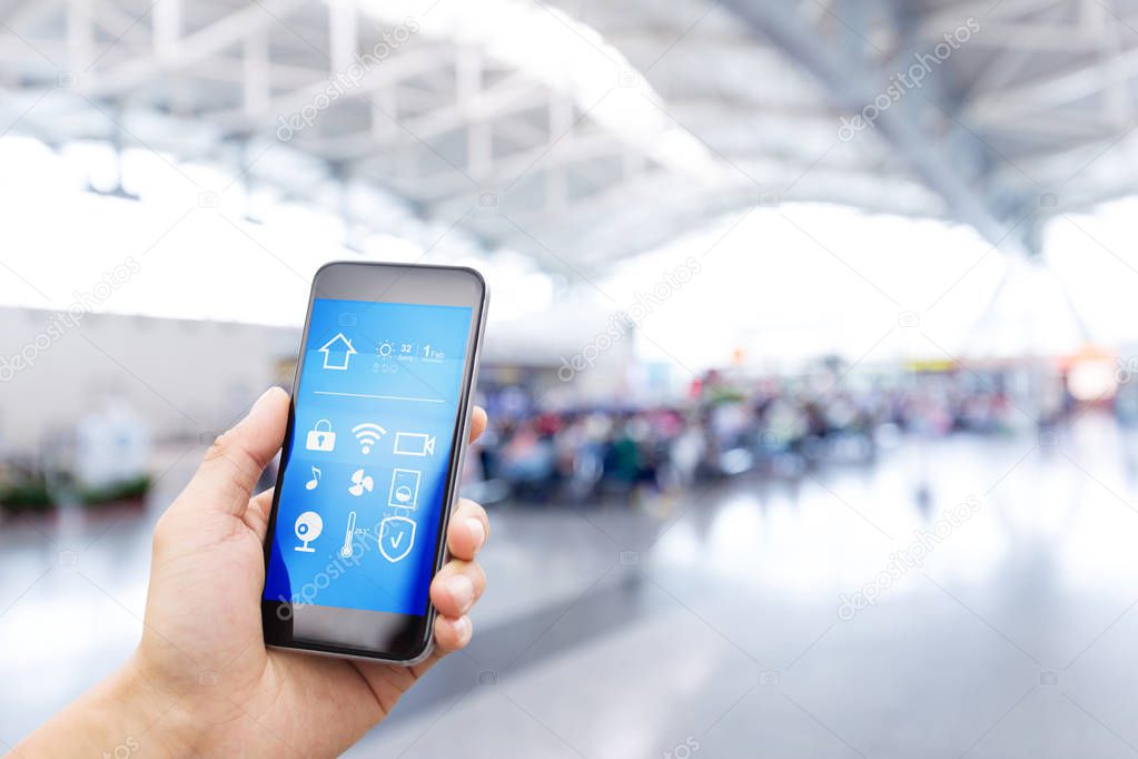 smartphone with smart home and modern airport hall