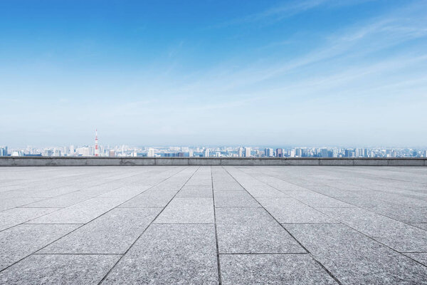 empty marble floor and cityscape of Tokyo in blue cloud sky