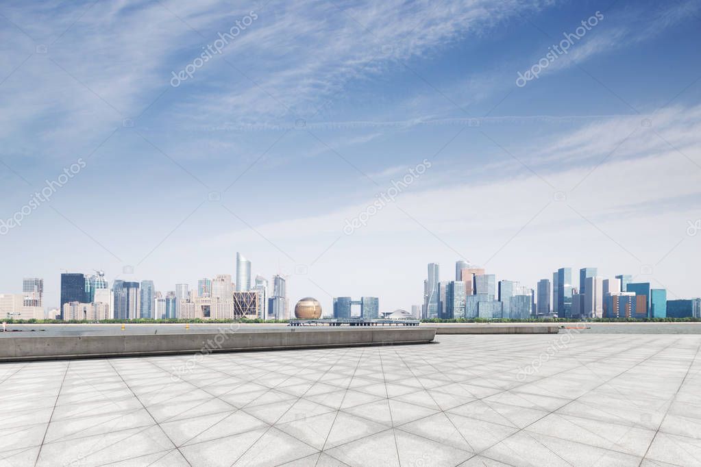 empty marble floor and cityscape of Hangzhou Qianjiang new city in blue cloud sky