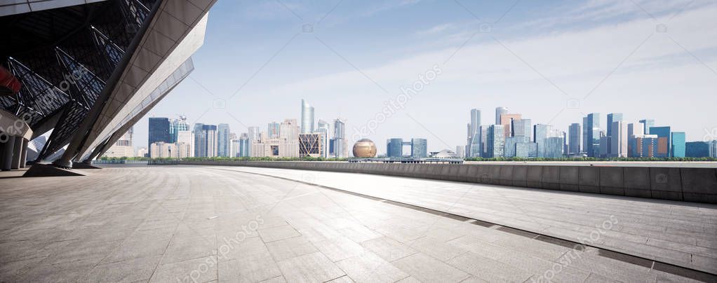 empty marble floor and cityscape of Hangzhou Qianjiang new city in blue cloud sky