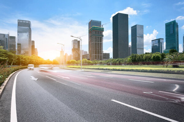 Asphalt road of a modern city with skyscrapers as background