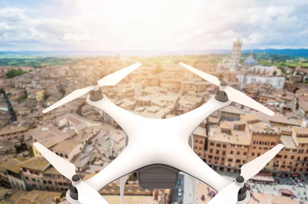 Drone with digital camera flying over an old city