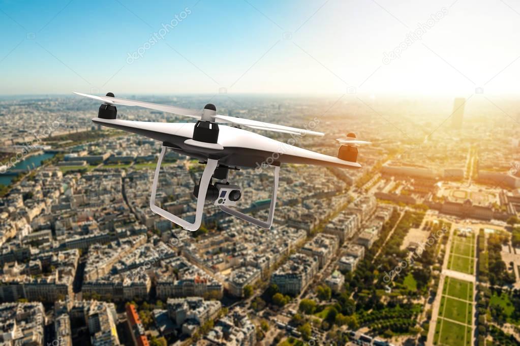 Drone with digital camera flying over a city