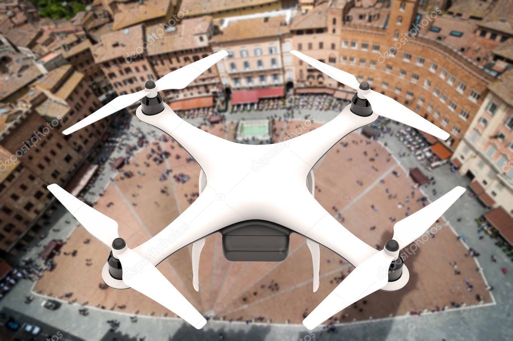 Drone with digital camera flying over a square of an italian city