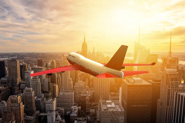 Airplane flying over a big metropoly — Stock Photo, Image