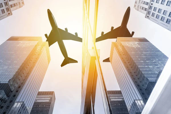 Airplane flying over skyscrapers — Stock Photo, Image