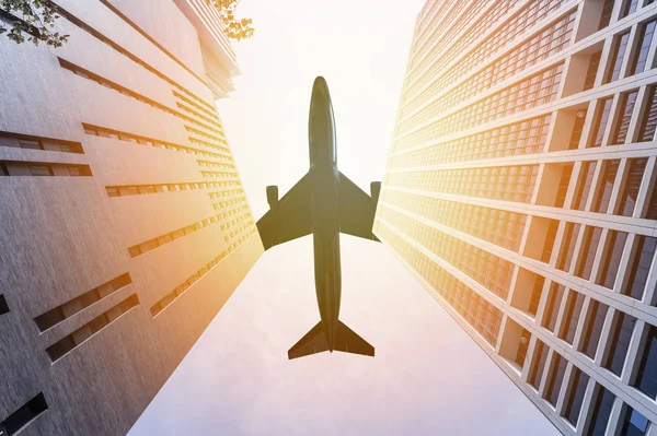 Airplane flying over two skyscrapers — Stock Photo, Image