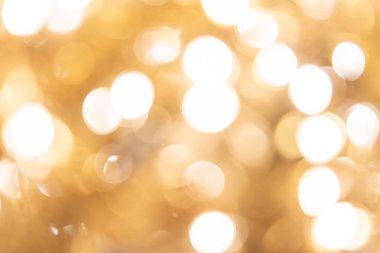 Noel arkaplanı. Bokeh odaklı ışıklar ve yıldızlarla süslü altın soyut arkaplan