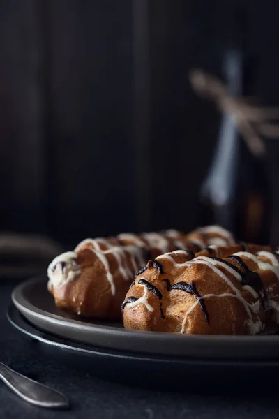 Sweet eclair dessert on black background — Stock Photo, Image