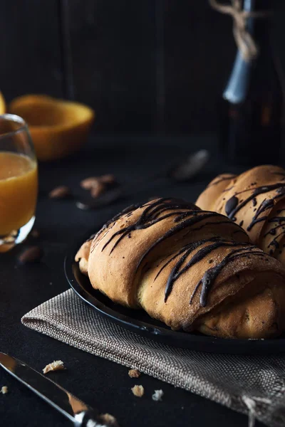 Fresh croissant with chocolate glaze on breakfast — Stock Photo, Image