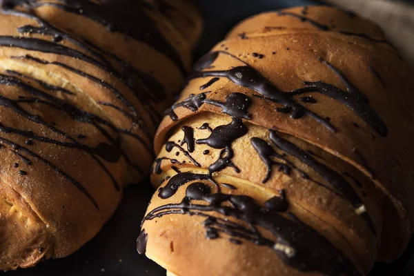 Fresh croissant with chocolate glaze on breakfast — Stock Photo, Image