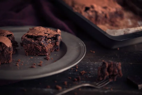 Brownie chocolate cake on dark moody background — Stock Photo, Image