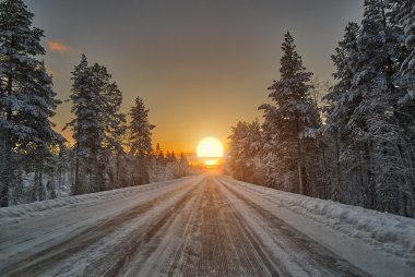 Finlandiya'da yol üzerinde kutup gece günbatımı