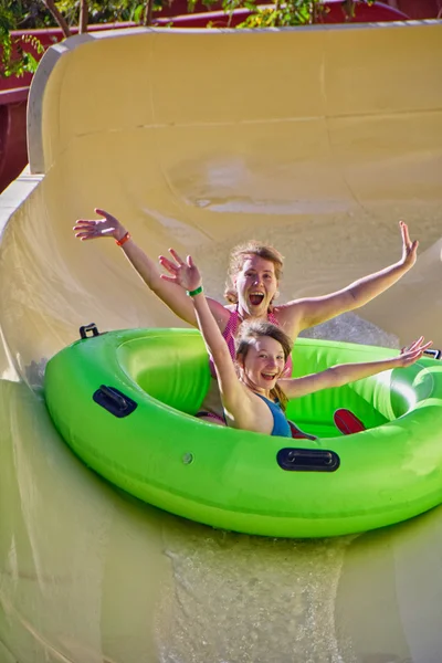 Happy family enjoy water slides in Aqua Park