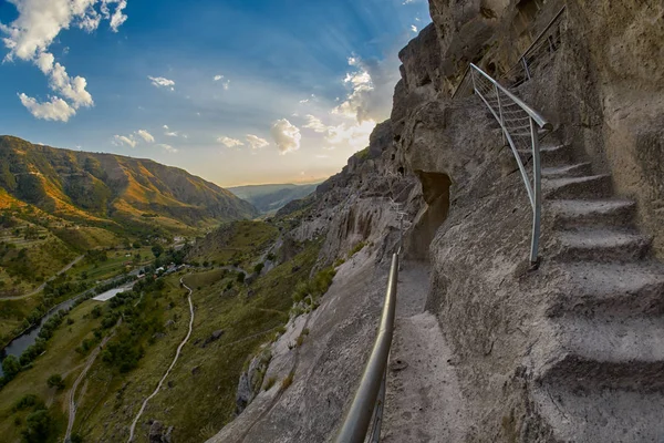 Climbing stairs of Vardzia cave city in Georgia — Stock Photo, Image