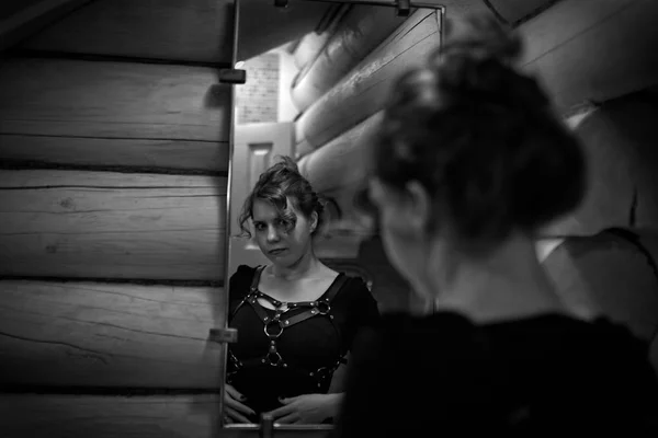 Redheaded νεαρή γυναίκα κοιτάζοντας τον εαυτό της στον καθρέφτη στο ba — Φωτογραφία Αρχείου