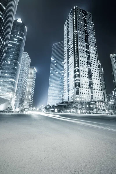 Modern buildings at night and road — Stock Photo, Image