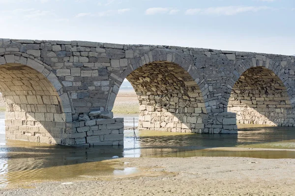 ancient stone arch bridge closeup, built in ming dynasty, revealed poyang lake in the dry season, jiangxi province, China