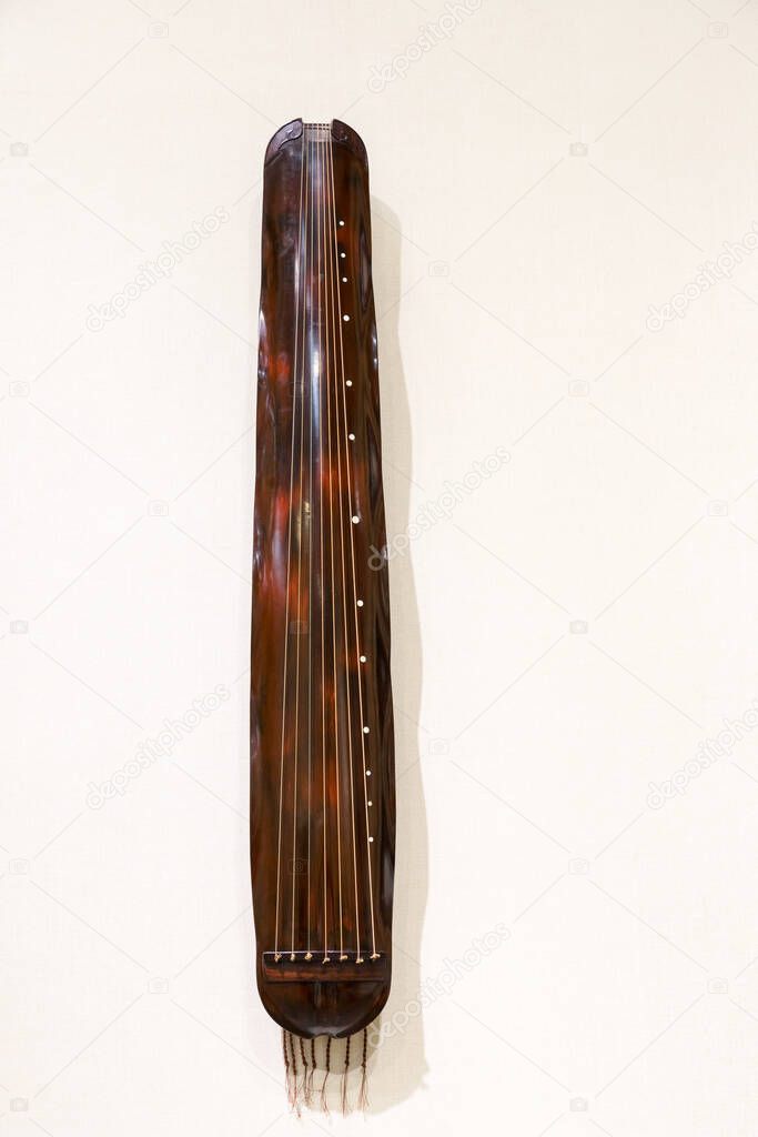 chinese traditional instrument of guqin, a seven-stringed plucked instrument in some ways similar to the zither