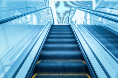 escalator of modern building with motion blur clipart