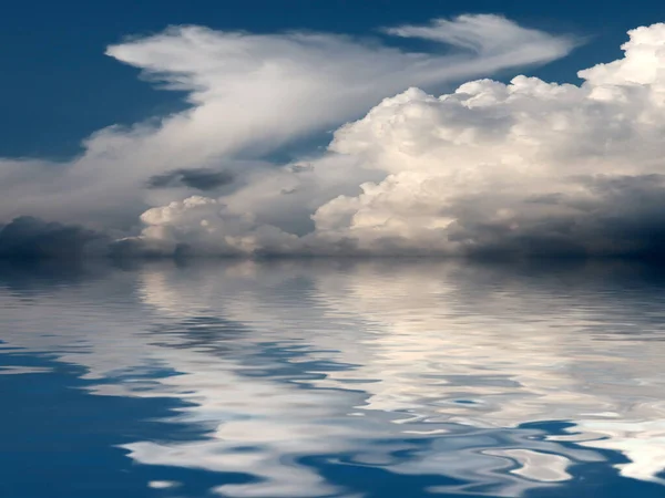 reflection of a cloudy sky in a calm surface of the sea