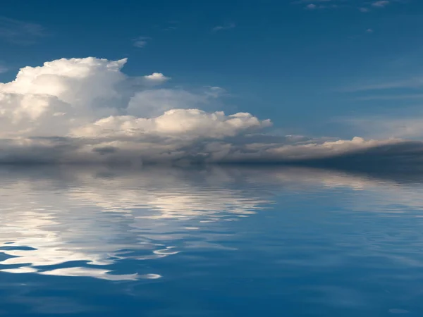 reflection of a cloudy sky in a calm surface of the sea