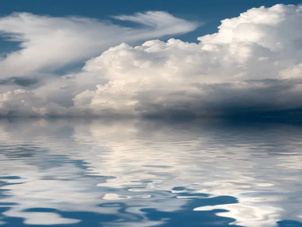 reflection of a cloudy sky in a calm surface of the sea