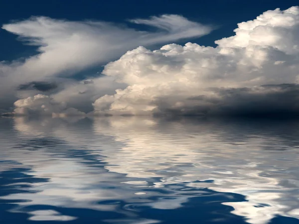 reflection of a cloudy sky in a calm surface of the sea