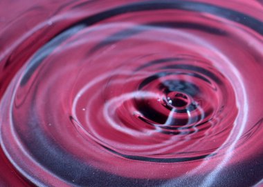 Bir damla sıvı su için suyun yüzeyine düşer.