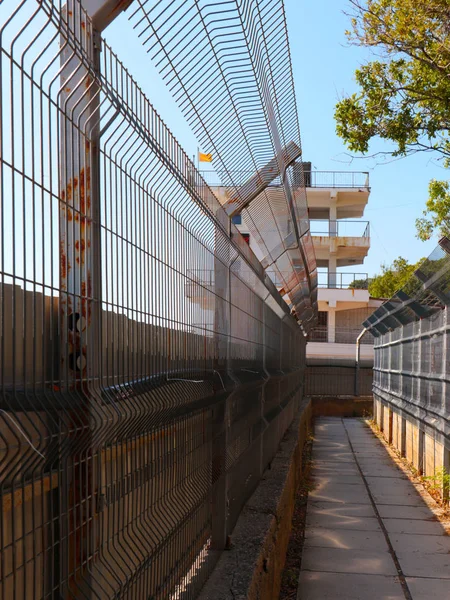 security fence along pedestrian walkway in restricted area