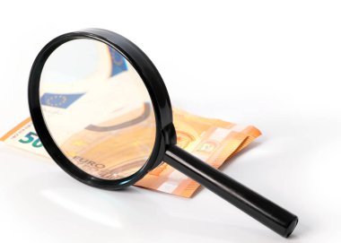 checking paper notes of the European Union Euro with a magnifying glass