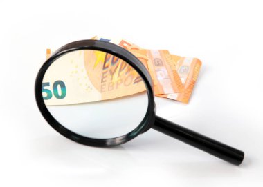 checking paper notes of the European Union Euro with a magnifying glass