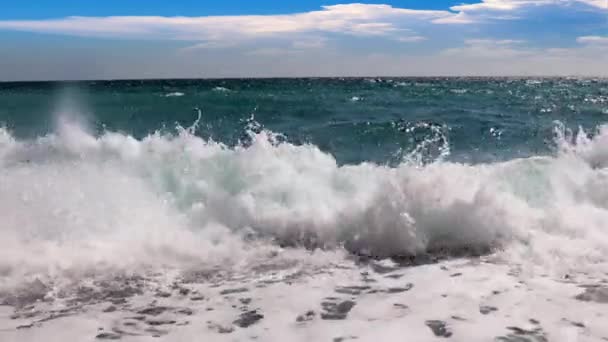 Θαλάσσια Κύματα Και Μια Παραλία Βότσαλα Κάτω Από Έναν Ηλιόλουστο — Αρχείο Βίντεο