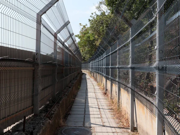 pedestrian passageway and metal fences of the border corridor fence