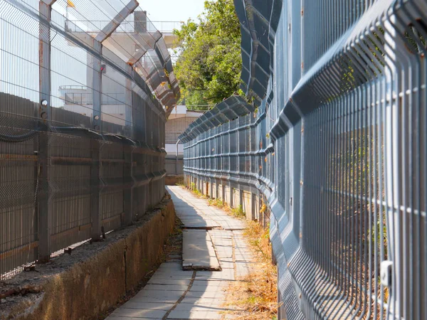 pedestrian passageway and metal fences of the border corridor fence