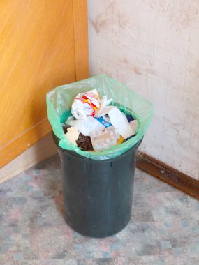 Yiyecek ve ev atığı dolu plastik bir kova.