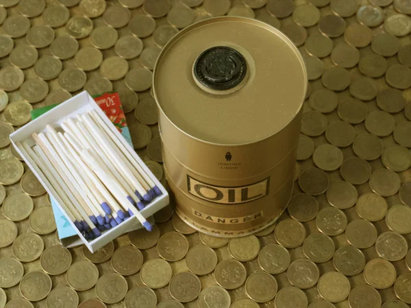 a box of matches and a barrel of oil stand on a pile of Russian coins as a symbol of the instability of the economic system