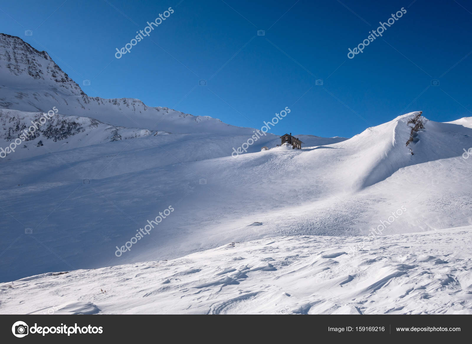 Alpine Refuge Below Mountain Ridge In Winter On Windswept Untracked Snow Stock P O Alpine Refuge Below Mountain Ridge In Winter On Windswept Untracked Snow Stock P O