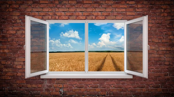 Parede de tijolo com janela e estrada para o horizonte — Fotografia de Stock