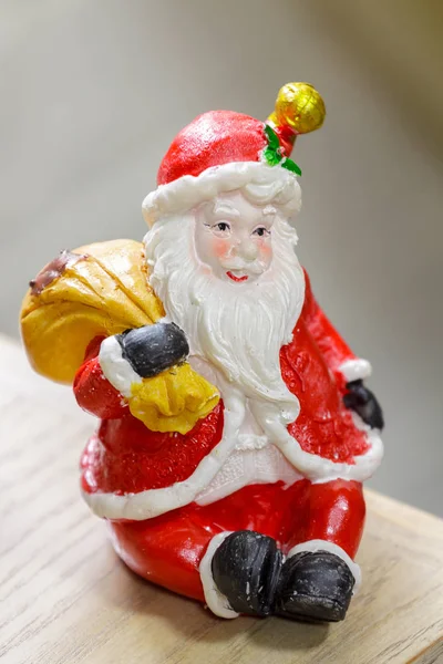 Figurine of a Santa sitting with a gift bag — Stock Photo, Image