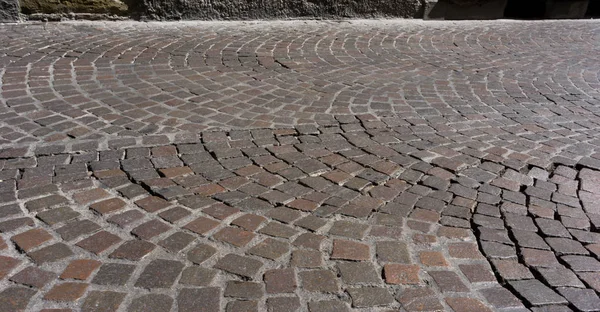 aged cobblestones road as background